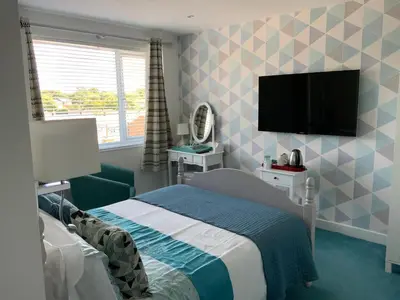 a bedroom with a bed and a flat screen tv at The Poacher in Stevenage