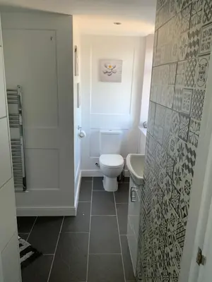 a white bathroom with a toilet and a sink at The Poacher in Stevenage