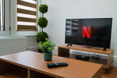 a living room with a tv and a remote control at Host & Stay - Maple Court in Ipswich