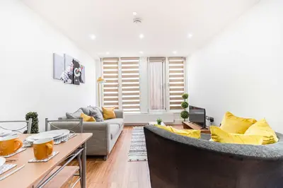 a living room with a couch and a table at Host & Stay - Maple Court in Ipswich