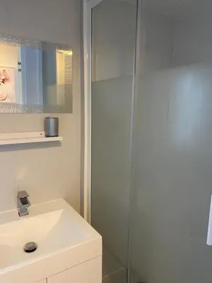 a bathroom with a sink and a shower at Cosy Caravan near the beach in Walton-on-the-Naze