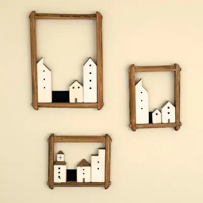 three mirrors on a wall with drawings of buildings at Greenacre Lodge - cosy, dog-friendly rural home with private garden in Redgrave