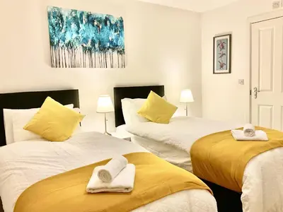 a bedroom with two beds with towels on them at Ocean-homestay in Colchester
