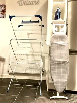 a metal cart in a kitchen next to a refrigerator at Ocean-homestay in Colchester