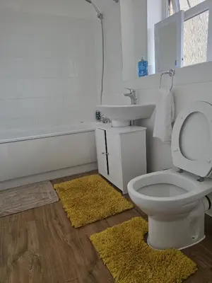 a bathroom with a toilet and a sink at Ocean-homestay in Colchester