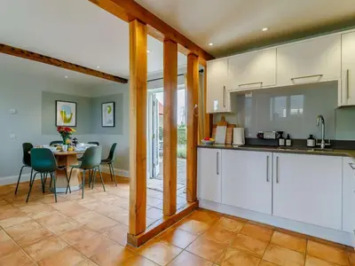 a kitchen and dining room with a table and chairs at 3 Bed in Saxmundham oc-89691 in Aldringham