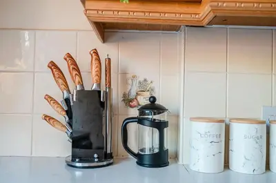 a kitchen counter with a blender and some breadsticks at Spacious & Elegant 3BR Home Near Ipswich City Centre in Ipswich