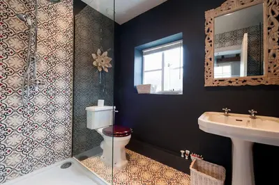 a bathroom with a toilet and a sink and a mirror at Charming Tudor riverside house in Wivenhoe