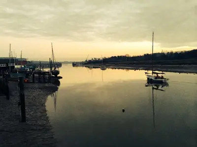 a group of boats docked at a dock in the water at Charming Tudor riverside house in Wivenhoe