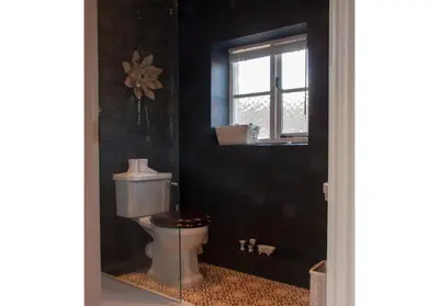 a bathroom with a toilet and a window at Charming Tudor riverside house in Wivenhoe