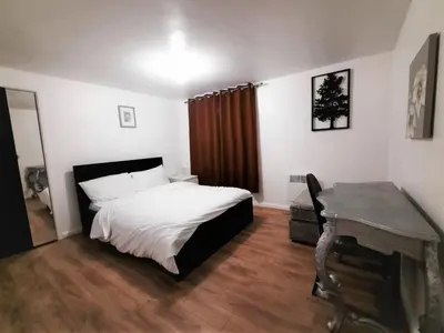 a bedroom with a bed and a desk in it at Colchester 3-Beds Sleeps 5 with Parking & WiFi in Colchester