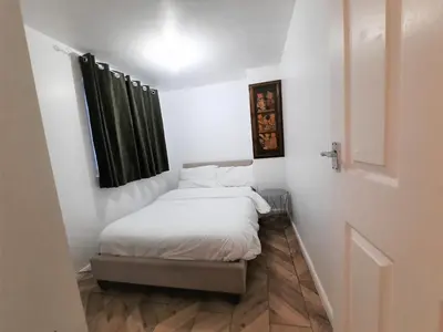 a small bedroom with a bed with white sheets at Colchester 3-Beds Sleeps 5 with Parking & WiFi in Colchester