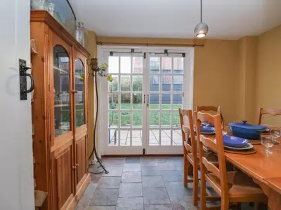 a dining room with a table and chairs and a window at 6 The Whinlands in Leiston