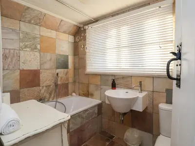 a bathroom with a sink and a tub and a toilet at 6 The Whinlands in Leiston