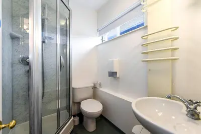 a bathroom with a toilet and a sink and a shower at Selwyn College, Cambridge in Cambridge