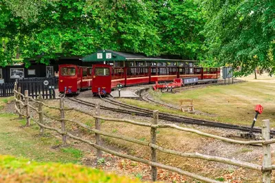a train on the tracks next to a fence at Guest House in Audley End in Saffron Walden