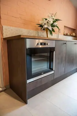 a kitchen with a counter with a microwave at Guest House in Audley End in Saffron Walden