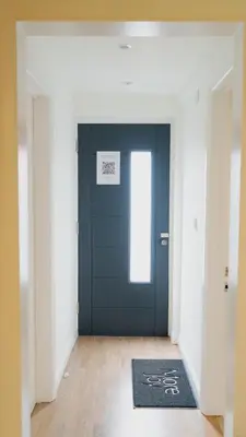 a blue door in a hallway with a rug at Exquisite 1-bedroom apartment with on-site parking in Braintree
