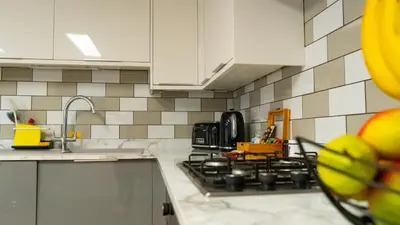 a kitchen with a sink and a stove top oven at Exquisite 1-bedroom apartment with on-site parking in Braintree