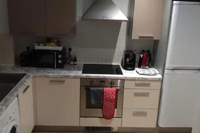a kitchen with white cabinets and a stove top oven at Apartment - Sleeps 4 - Parking - WiFi in Colchester