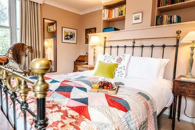 a bedroom with a bed with a bowl of fruit on it at 29 Wentworth Road, Aldeburgh in Aldeburgh
