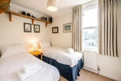 two beds in a room with a window at 29 Wentworth Road, Aldeburgh in Aldeburgh