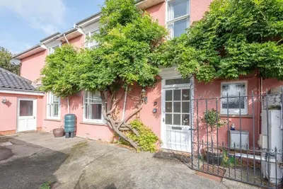 a pink house with a gate in front of it at 29 Wentworth Road, Aldeburgh in Aldeburgh