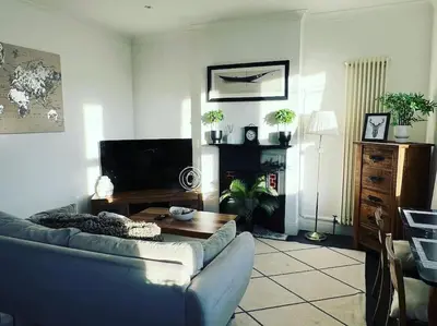 a living room with a couch and a table at Hill Grove 2 Bedroom Apartment in Leigh-on-Sea