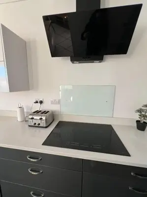 a kitchen with a counter top with a television on it at Hill Grove 2 Bedroom Apartment in Leigh-on-Sea
