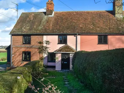 a pink house with a pathway leading to it at Cherry Cottage in Ipswich