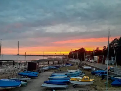 a bunch of boats are lined up on the beach at Cherry Cottage in Ipswich