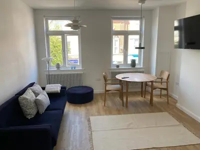a living room with a couch and a table at The Studio in Frinton-on-Sea
