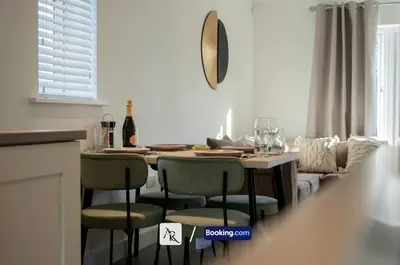 a kitchen with a table with chairs and a couch at 2 Bedroom House By AR Properties Short Lets & Serviced Accommodation Colchester with Garden in Colchester