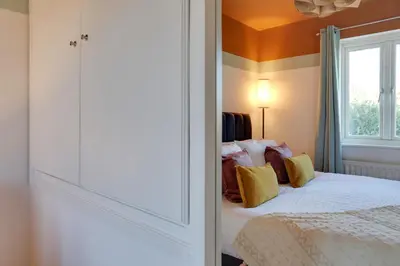 a bedroom with a bed and a window at Cosy Two bedroom house - Chelmsford - Free Parking and Wifi in Chelmsford