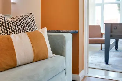 a couch sitting in a living room next to a door at Cosy Two bedroom house - Chelmsford - Free Parking and Wifi in Chelmsford