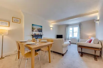 a living room with a wooden table and chairs at 3 Bed in Woodbridge oc-tst in Melton