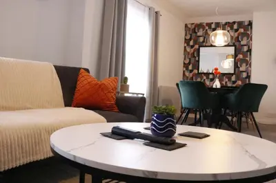 a living room with a couch and a table at Spacious 2BR Apartment Central Colchester Near Station Fast WIFI in Colchester