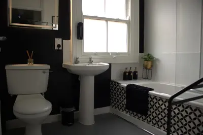 a bathroom with a toilet and a sink and a tub at Spacious 2BR Apartment Central Colchester Near Station Fast WIFI in Colchester