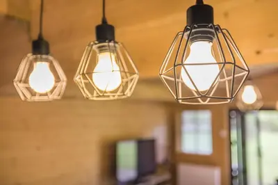 a group of lights hanging from a ceiling at Cabin in the countryside in Sible Hedingham