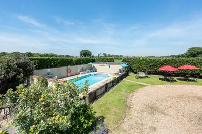 an estate with a swimming pool and a yard at Birds Farm in Colchester