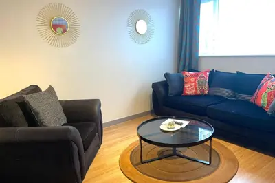a living room with a couch and a coffee table at House - Sleeps 10 - Garden - Parking in Romford