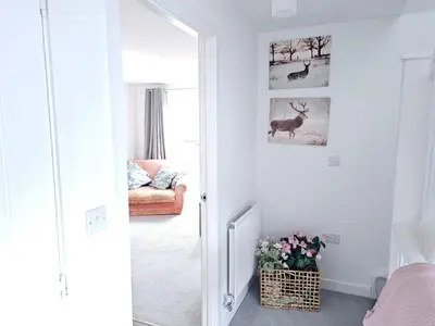 a bedroom with a door leading into a room with a deer picture at Ipswich - 3 Beds - Sleeps 6 - Private Garden in Ipswich