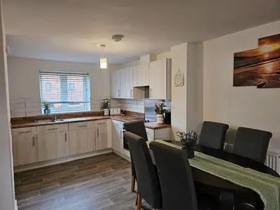 a kitchen with a table and chairs and a dining room at Ipswich - 3 Beds - Sleeps 6 - Private Garden in Ipswich
