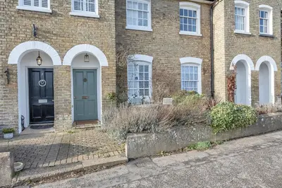 a brick house with a blue door and windows at Charming Church Walk, Long Melford - 2 bedroom property with parking in Long Melford