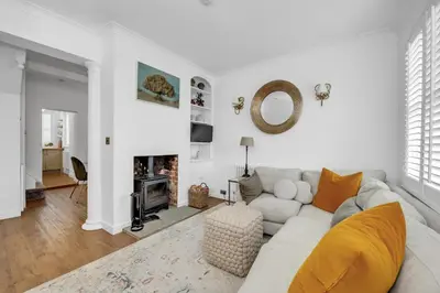 a white living room with a couch and a fireplace at Charming Church Walk, Long Melford - 2 bedroom property with parking in Long Melford