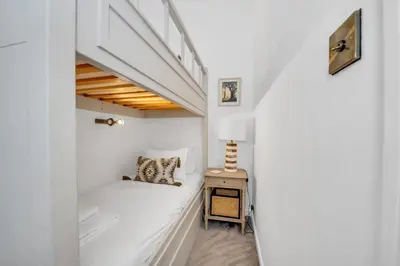 a small white room with a bed and a table at Charming Church Walk, Long Melford - 2 bedroom property with parking in Long Melford