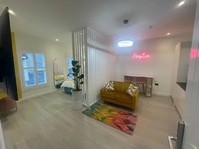 a living room with a couch and a table at Stylish Studio in Colchester