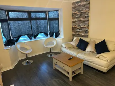 a living room with a couch and two chairs at Contractor & Family Friendly House Romford in Havering atte Bower