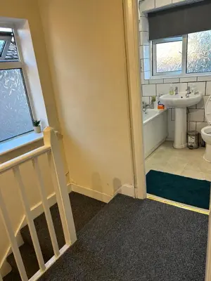 a bathroom with a staircase and a sink and a toilet at Contractor & Family Friendly House Romford in Havering atte Bower