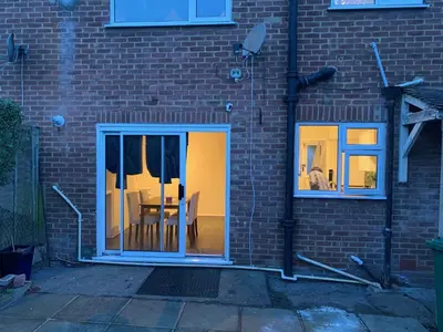 a brick building with a door with a table in it at Contractor & Family Friendly House Romford in Havering atte Bower